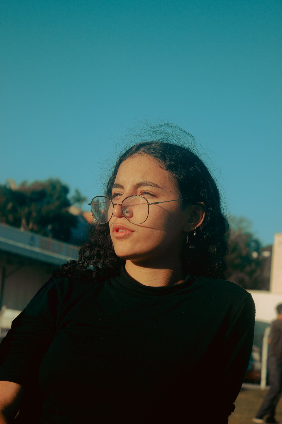 Portrait with visible reflections in the eyeglass lenses.