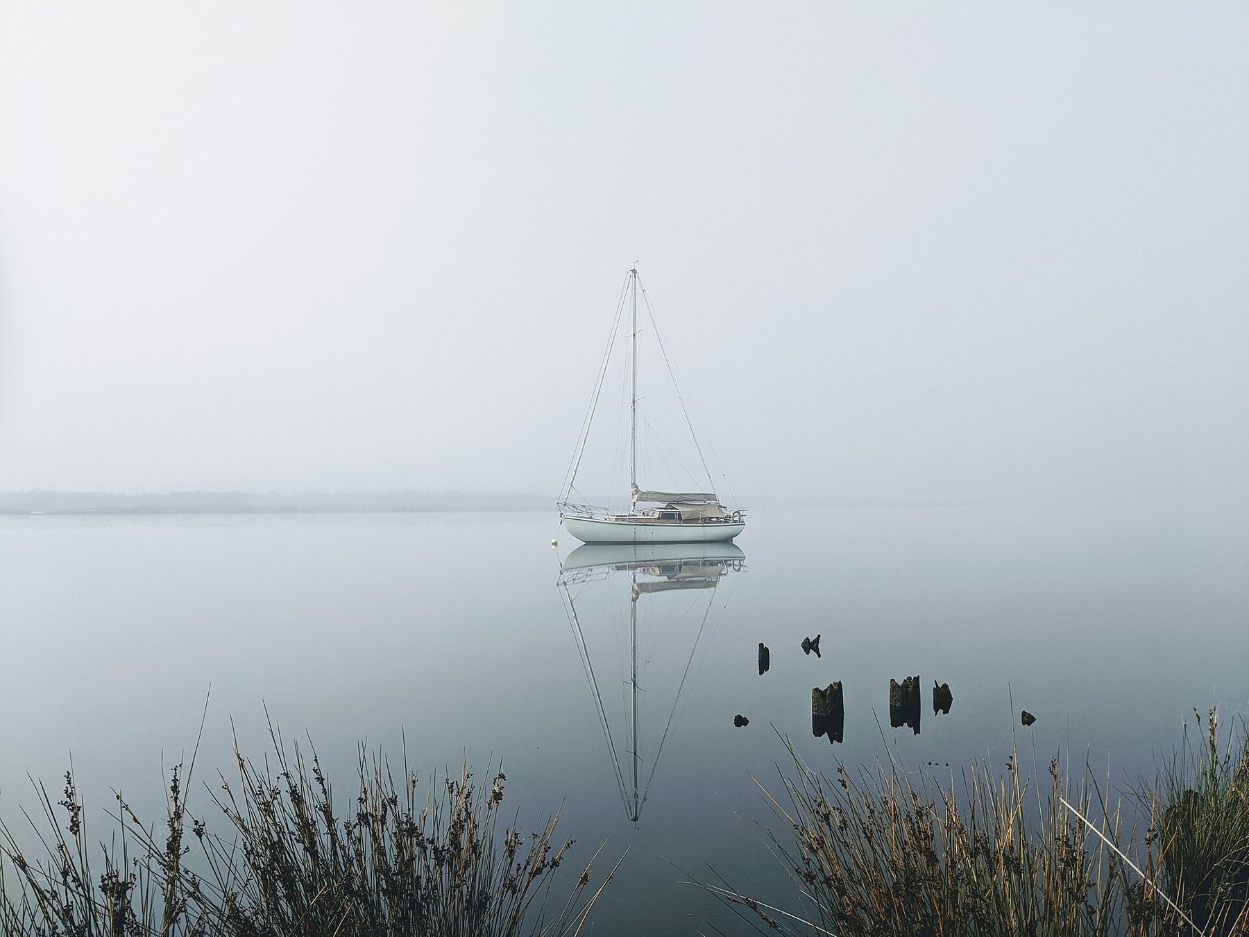 A sailboat on the Huon River in fog.