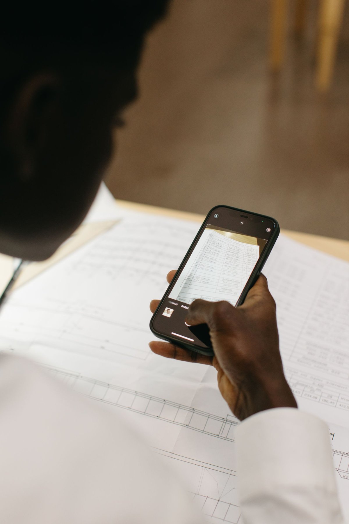 A smartphone above a document.
