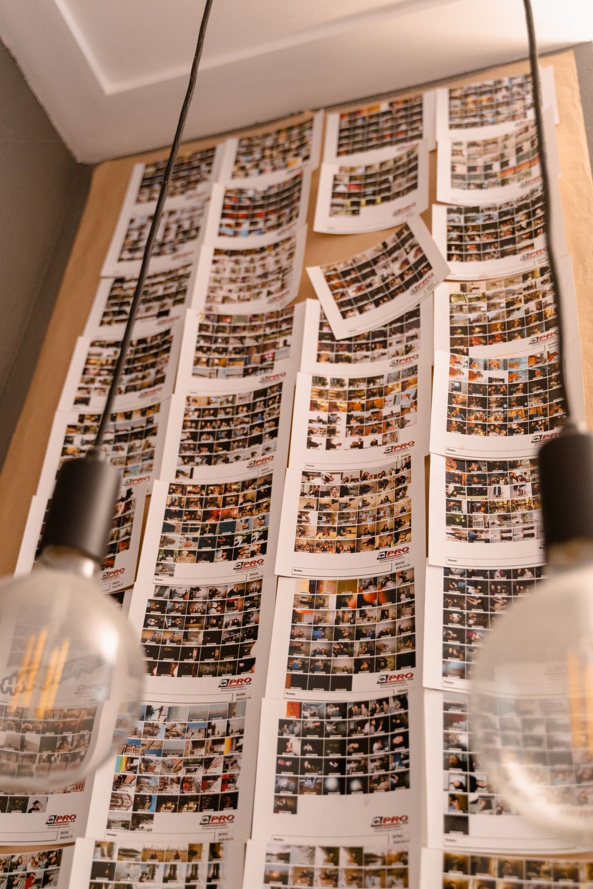 A photo wall under artificial lighting.