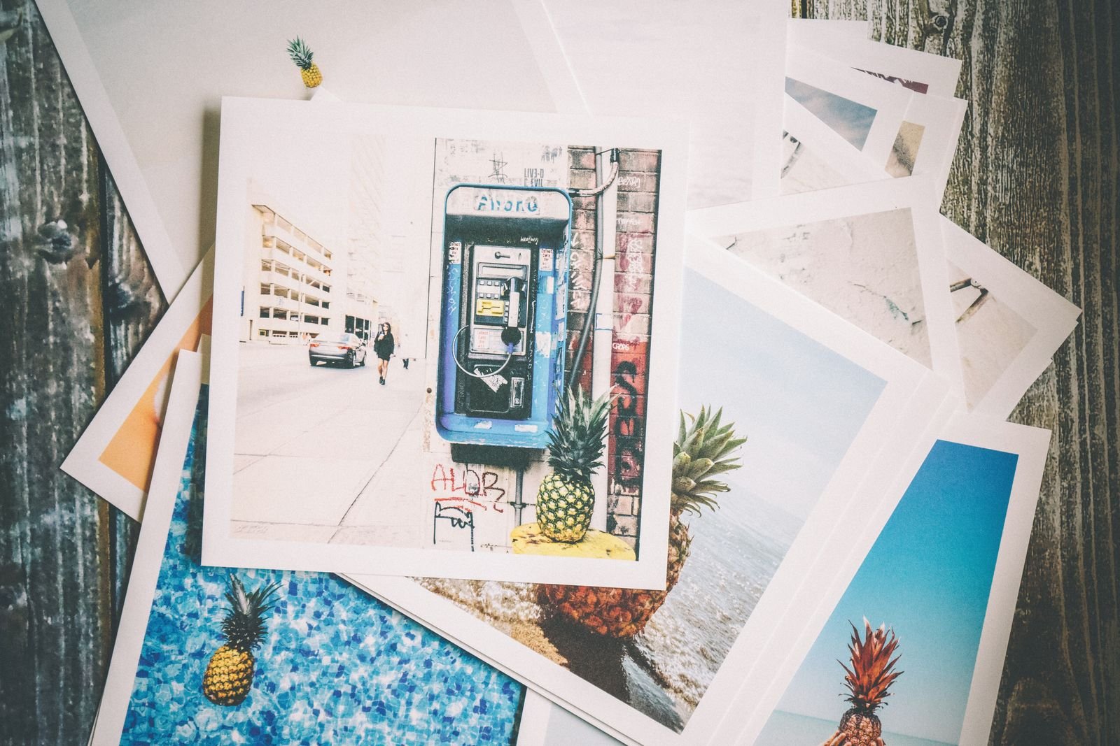 A stack of loose photographic prints.